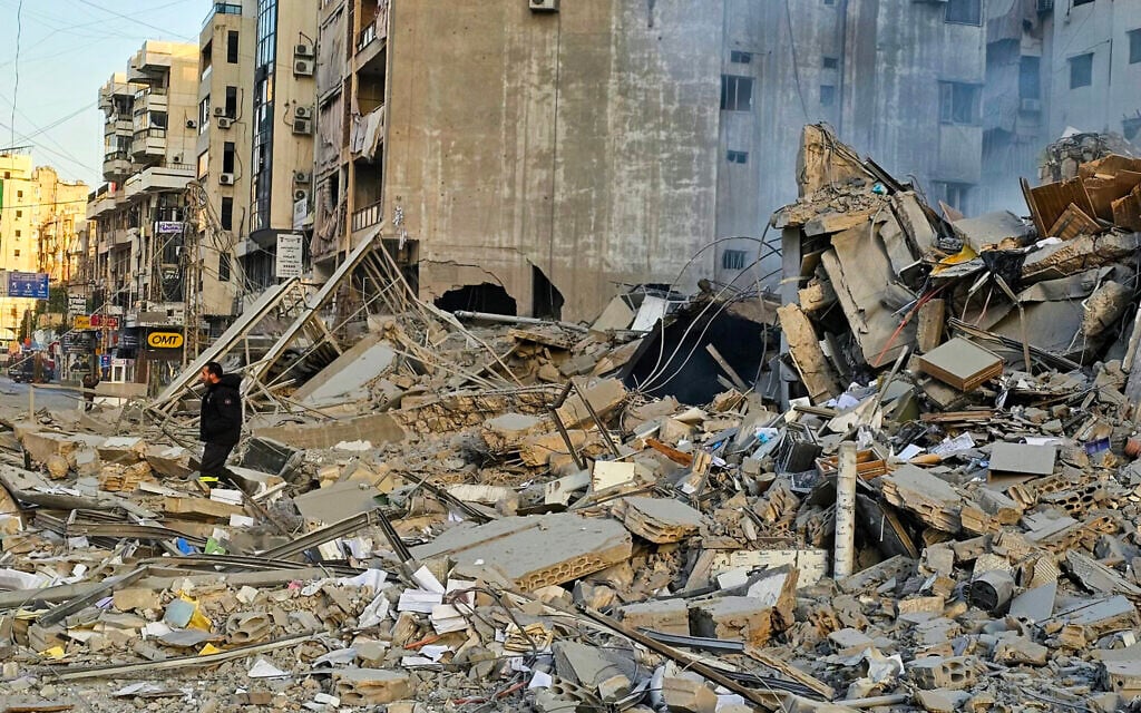 A man walks amid the rubble of a building at the site of overnight Israeli airstrikes in the southern suburbs of Beirut on March 6, 2026. (AFP)