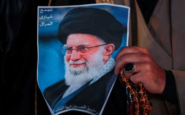 A Shiite Muslim man hold a poster of the late Iranian supreme leader Ayatollah Ali Khamenei during a rally in Tahrir Square, in Baghdad on March 6, 2026. (Murtaja LATEEF / AFP)