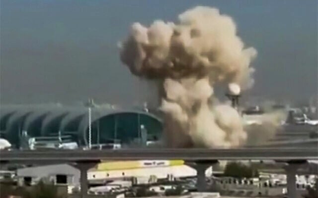 This video grab taken from UGC images posted on social media on March 7, 2026 shows smoke rising from the Dubai International Airport (Photo by various sources / AFP)