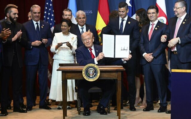US President Donald Trump holds up a newly-signed proclamation at the "Shield of the Americas" Summit at Trump National Doral in Miami, Florida, March 7, 2026. (Saul Loeb / AFP) US President Donald Trump holds up a newly-signed proclamation at the "Shield of the Americas" Summit at Trump National Doral in Miami, Florida, March 7, 2026. (Saul Loeb / AFP)