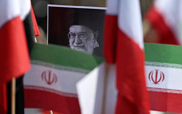A protestor holds a placard with an image of the late Iranian Supreme Leader Ayatollah Ali Khamenei surrounded by Iranian flags outside the US consulate during a protest against the conflict in the Middle East in Mexico City on March 7, 2026. (Carl de Souza / AFP) A protestor holds a placard with an image of the late Iranian Supreme Leader Ayatollah Ali Khamenei surrounded by Iranian flags outside the US consulate during a protest against the conflict in the Middle East in Mexico City on March 7, 2026. (Carl de Souza / AFP)