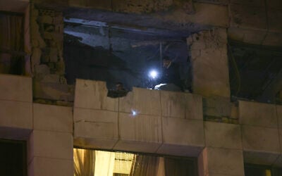 First aid responders inspect a Ramada Hotel room targeted by an Israeli strike, in Beirut's Rawche area, on March 8, 2026. (Ibrahim AMRO / AFP)