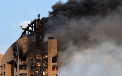 Smoke rises from a high-rise building following a drone attack in Kuwait City on March 8, 2026 (AFP)