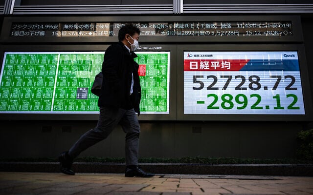 A man walks past an electronic quotation board displaying numbers of the Nikkei Stock Average on the Tokyo Stock Exchange along a street in Tokyo on March 9, 2026. (Philip FONG / AFP) A man walks past an electronic quotation board displaying numbers of the Nikkei Stock Average on the Tokyo Stock Exchange along a street in Tokyo on March 9, 2026. (Philip FONG / AFP)