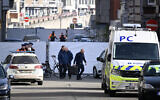 Belgian police conduct their investigation outside a synagogue that was his by a blast overnight in Liege, Belgium, March 9, 2026. (John Thys/AFP)