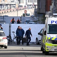 Belgian police conduct their investigation outside a synagogue that was his by a blast overnight in Liege, Belgium, March 9, 2026. (John Thys/AFP)
