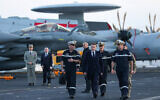 French President Emmanuel Macron (C) visits the French aircraft carrier Charles de Gaulle, deployed to the Mediterranean following Iranian drone strikes on Cyprus on the Mediterranean Sea, on March 9, 2026, on the sidelines of his trip to Cyprus to discuss regional security. (Gonzalo Fuentes / POOL / AFP)