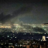 Smoke plumes billow from the site of airstrikes near Azadi Tower in western Tehran on March 10, 2026. (ATTA KENARE / AFP)