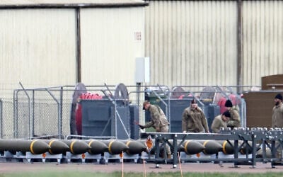 Members of the US Air Force (USAF) prepare munitions at RAF Fairford in southwest England on March 10, 2026, after USAF B-1 Lancer bomber jets and Air Force Boeing B-52 Stratofortress bombers landed at the RAF base.  (Photo by Henry NICHOLLS / AFP)