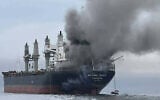 This handout photo taken on March 11, 2026, and released by the Royal Thai Navy, shows smoke rising from the Thai bulk carrier 'Mayuree Naree' near the Strait of Hormuz after an attack. (Handout / Royal Thai Navy/AFP)