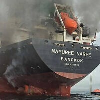 This handout photo taken on March 11, 2026 and released by the Royal Thai Navy shows smoke rising from the Thai bulk carrier 'Mayuree Naree' near the Strait of Hormuz after an attack, March 11, 2026. (ROYAL THAI NAVY / AFP)