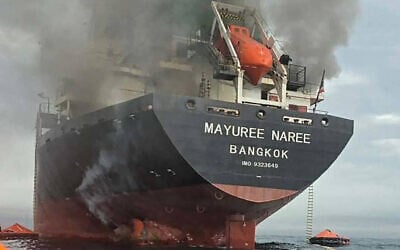 This handout photo taken on March 11, 2026 and released by the Royal Thai Navy shows smoke rising from the Thai bulk carrier 'Mayuree Naree' near the Strait of Hormuz after an attack, March 11, 2026. (ROYAL THAI NAVY / AFP)