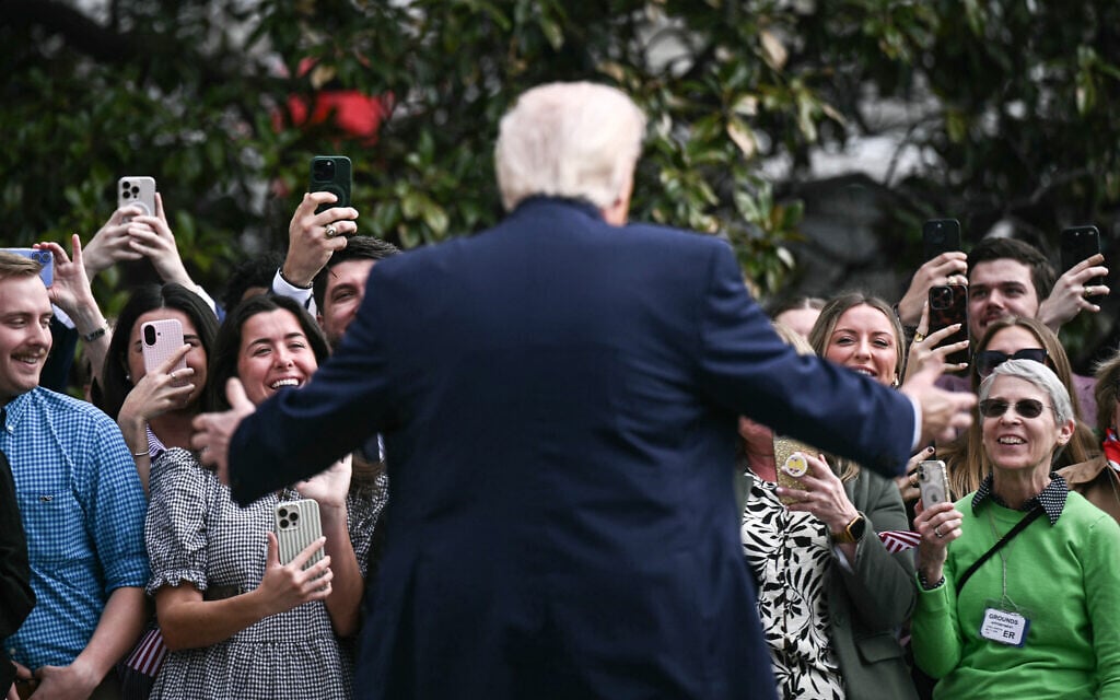 US President Donald Trump speaks to guests on his way to board Marine One as he departs from the South Lawn of the White House in Washington, DC, on March 11, 2026.(Brendan SMIALOWSKI / AFP)