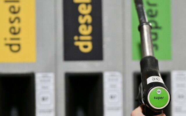 A person holds a petrol pump near Monza, northern Italy on March 11, 2026 (Stefano RELLANDINI / AFP) A person holds a petrol pump near Monza, northern Italy on March 11, 2026 (Stefano RELLANDINI / AFP)