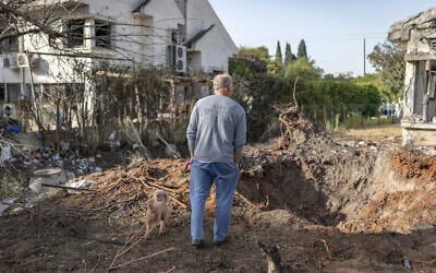 A man looks at the damage after a house was hit by a rocket reportedly fired by Hezbollah in central Israel on March 12, 2026. (Ilia YEFIMOVICH / AFP) A man looks at the damage after a house was hit by a rocket reportedly fired by Hezbollah in central Israel on March 12, 2026. (Ilia YEFIMOVICH / AFP)