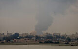 A plume of smoke rises after a reported Iranian strike on fuel tanks in Muharraq, Bahrain, on March 12, 2026. (Fadhel MADHAN / AFP) /