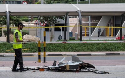 Illustrative: A policeman inspects the wreckage of a drone in downtown Dubai on March 12, 2026. (AFP)