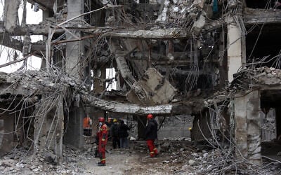 Rescue workers stand amid the rubble of a destroyed building in Tehran on March 12, 2026. (AFP) Rescue workers stand amid the rubble of a destroyed building in Tehran on March 12, 2026. (AFP)