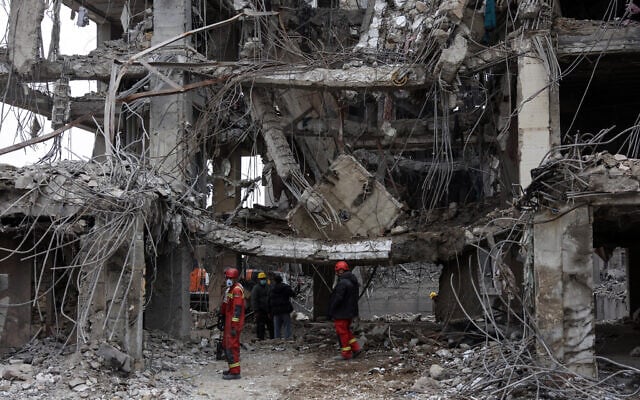 Rescue workers stand amid the rubble of a destroyed building in Tehran on March 12, 2026. (AFP) Rescue workers stand amid the rubble of a destroyed building in Tehran on March 12, 2026. (AFP)