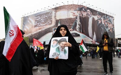 Illustrative: An Iranian woman holds an image of the new Iranian supreme leader Ayatollah Mojtaba Khamenei as she takes part in the Al-Quds (Jerusalem) Day rally, an Iranian government show of support for the Palestinian people held on the last Friday of the Islamic holy month of Ramadan, in Tehran, Iran on March 13, 2026. (AFP)