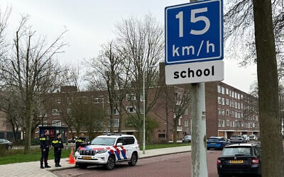 A police car parked outside a Jewish school in Amsterdam, where an explosion was reported overnight, March 14, 2026. (Stéphanie HAMEL / AFP)