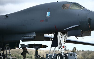 Joint Direct Attack Munitions (JDAMs) are taken from a US Air Force B-1 Lancer bomber at RAF Fairford in southwest England on March 15, 2026. (Henry Nicholls/AFP)
