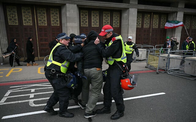 Police arrest a protester for not removing a face covering during an annual protest held by pro-Palestinian group Al-Quds in central London on March 15, 2026. (JUSTIN TALLIS / AFP) Police arrest a protester for not removing a face covering during an annual protest held by pro-Palestinian group Al-Quds in central London on March 15, 2026. (JUSTIN TALLIS / AFP)