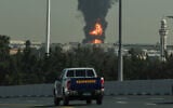 A smoke plume rises from a fire sparked by an Iranian drone attack at Dubai International Airport in Dubai on March 16, 2026.  (AFP)