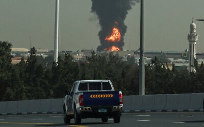 A smoke plume rises from a fire sparked by an Iranian drone attack at Dubai International Airport in Dubai on March 16, 2026.  (AFP)