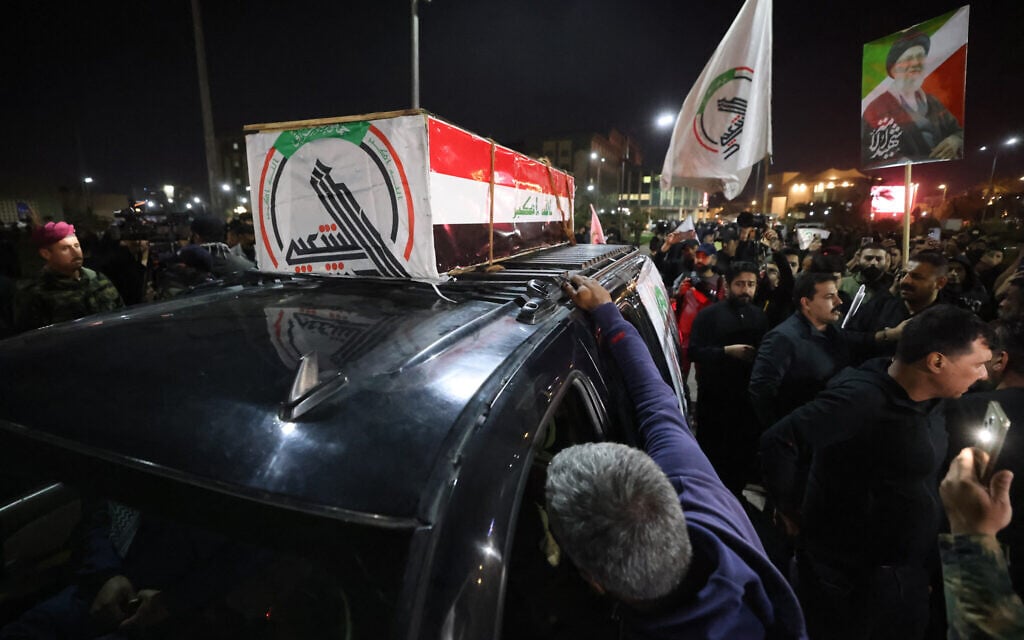 A photo of slain Iranian supreme leader Ayatollah Ali Khamenei is held as mourners attend a funeral for members of Iraq's Hashed al-Shaabi, who were killed in an attack in al-Qaim province near the Syria border the previous evening, in Baghdad on March 17, 2026. (AHMAD AL-RUBAYE / AFP) / A photo of slain Iranian supreme leader Ayatollah Ali Khamenei is held as mourners attend a funeral for members of Iraq's Hashed al-Shaabi, who were killed in an attack in al-Qaim province near the Syria border the previous evening, in Baghdad on March 17, 2026. (AHMAD AL-RUBAYE / AFP) /