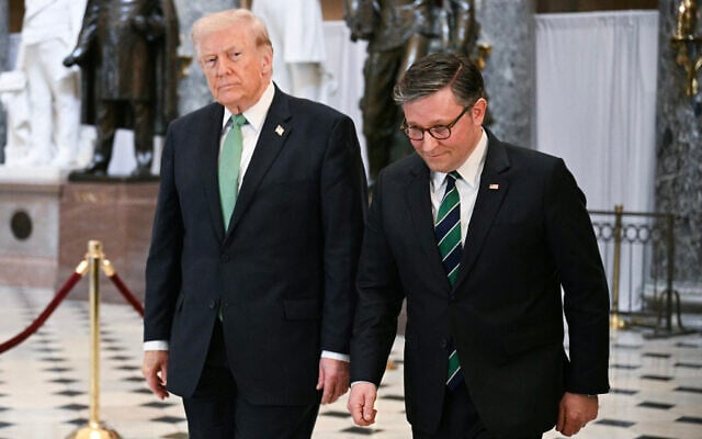 US President Donald Trump and US House Speaker Mike Johnson walk through the Statuary Hall on Capitol Hill after a Friends of Ireland luncheon in Washington, DC, on March 17, 2026. (Jim Watson/AFP)