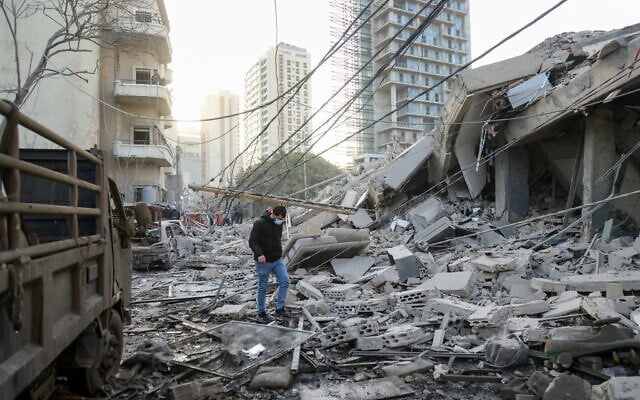 A man walks through rubble at the site of an Israeli airstrike in central Beirut on March 18, 2026. (Ibrahim Amro / AFP) A man walks through rubble at the site of an Israeli airstrike in central Beirut on March 18, 2026. (Ibrahim Amro / AFP)
