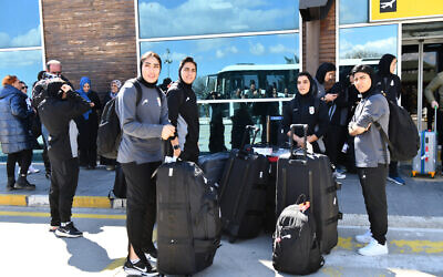 Members of Iran's women's soccer team stand at Turkey's Igdir airport, waiting to reach Dogubeyazit, in Igdir on March 18, 2026 (Ali IHSAN OZTURK / AFP)
