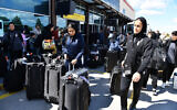 Members of Iran's women's soccer team exit Turkey's Igdir airport, on March 18, 2026. (Ali IHSAN OZTURK / AFP)