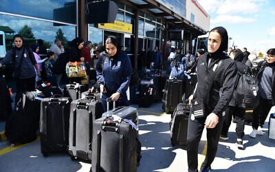 Members of Iran's women's soccer team exit Turkey's Igdir airport, on March 18, 2026. (Ali IHSAN OZTURK / AFP)