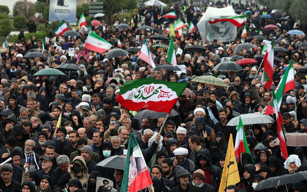 Mourners march during the funeral ceremony for Iran's slain intelligence minister Esmail Khatib and his family after the weekly Friday Muslim noon prayers in Tehran on March 20, 2026. (Photo by AFP)