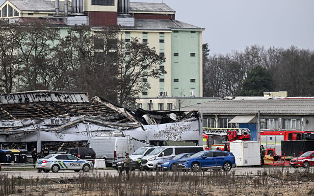 Firefighters and investigators check the scene of the burnt factory owned by Czech arms maker LPP Holding, March 20, 2026, in Pardubice, Czech Republic. (Michal Cizek / AFP)