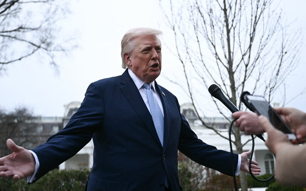 US President Donald Trump speaks to journalists before boarding Marine One as he departs from the South Lawn of the White House in Washington, DC, on March 20, 2026 for his Mar-a-Lago residence, where he will spend the weekend. (Photo by Brendan SMIALOWSKI / AFP)