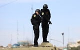 Iranian security forces stand guard on top of an armored vehicle during the funeral ceremony of Iran's Revolutionary Guards spokesperson Ali Mohammad Naini, who was killed in US-Israeli strikes, in Tehran on March 21, 2026. (AFP)