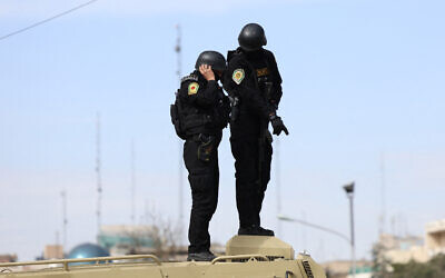 Iranian security forces stand guard on top of an armored vehicle during the funeral ceremony of Iran's Revolutionary Guards spokesperson Ali Mohammad Naini, who was killed in US-Israeli strikes, in Tehran on March 21, 2026. (AFP)