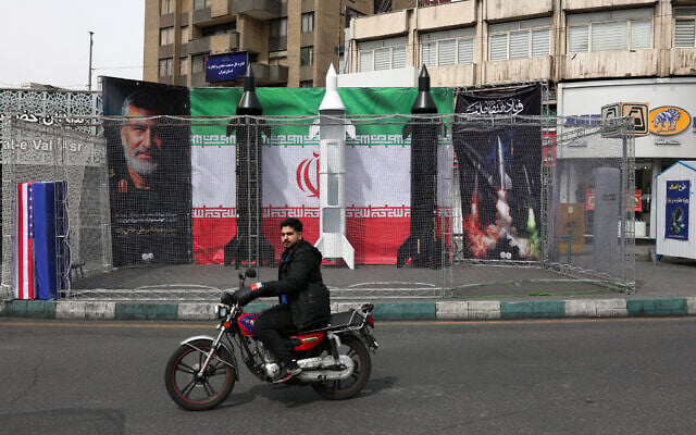 A motorist rides past the dummy models of Iranian missiles installed along the roadside at the Valiasr Square, in Tehran, Iran, on March 22, 2026. (AFP) A motorist rides past the dummy models of Iranian missiles installed along the roadside at the Valiasr Square, in Tehran, Iran, on March 22, 2026. (AFP)