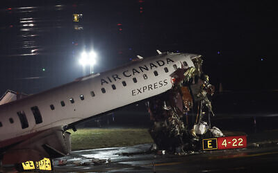An Air Canada Express CRJ-900 sits on the runway after colliding with a Port Authority fire truck at LaGuardia Airport in New York, on March 23, 2026 (ANGELA WEISS / AFP)