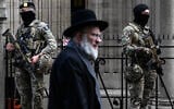Belgian military personnel stand guard outside a synagogue in central Antwerp as part of Belgium's reinforced security measures established at Jewish schools and synagogues, March 23, 2026. (John Thys/AFP)