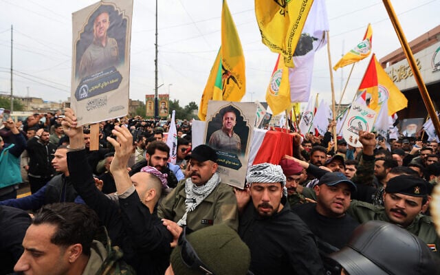 Members of Iraq's Popular Mobilization Forces take part in a funeral of one of the people killed in a strike attributed to the US, in Baghdad on March 24, 2026. (Ahmad Al-Rubaye/AFP) Members of Iraq's Popular Mobilization Forces take part in a funeral of one of the people killed in a strike attributed to the US, in Baghdad on March 24, 2026. (Ahmad Al-Rubaye/AFP)