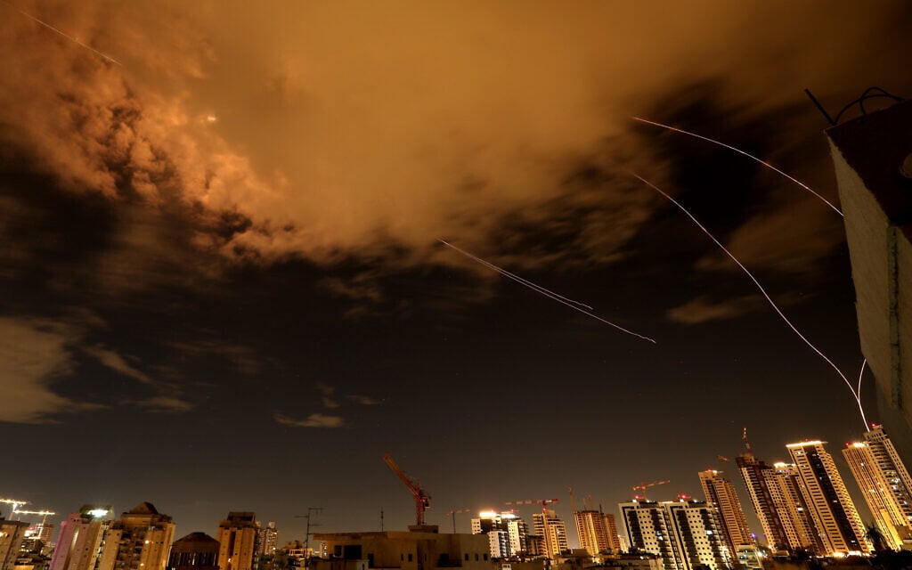 Rocket trails are seen in the sky above the Israeli coastal city of Netanya amid a fresh barrage of Iranian missile attacks on March 25, 2026. (Photo by JACK GUEZ / AFP) /