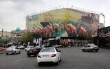 Vehicles move along Revolution Square in central Tehran, Iran, on March 25, 2026. (AFP) /
