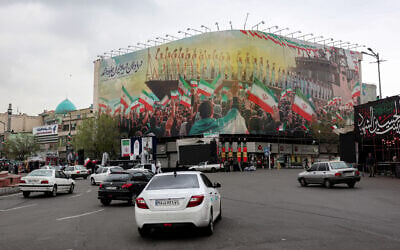 Vehicles move along Revolution Square in central Tehran, Iran, on March 25, 2026. (AFP) /