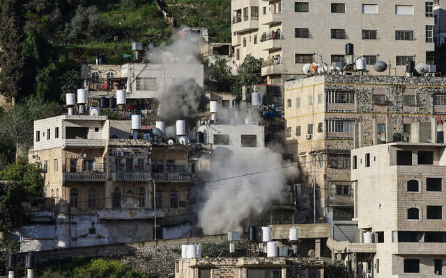 Smoke rises as the IDF demolishes the home of Mahmoud al-Qadi, who killed an Israeli soldier in a car-ramming attack, in the West Bank city of Nablus on March 28, 2026. (Jaafar Ashtiyeh/AFP)