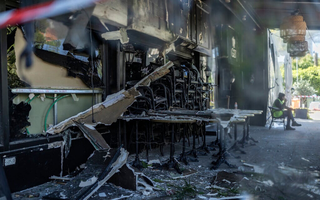 A photograph shows the damage at a site hit overnight by fragments of an Iranian missile in Ramat Gan, on March 28, 2026. (Ilia YEFIMOVICH / AFP) /