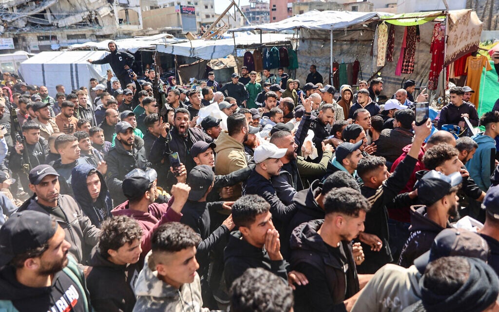 Mourners carry the bodies of Fahmi and Saed Qaddoum, two Palestinian brothers reportedly killed earlier in the day in an Israeli airstrike on Gaza City's Shejaiya neighborhood, during their funeral in Gaza City, March 28, 2026. (Omar AL-QATTAA / AFP)